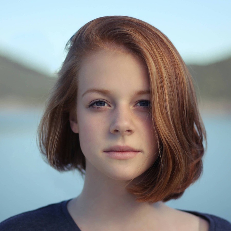 Photo of a woman with auburn hair, the face on the example card